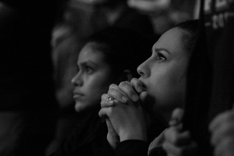 women sitting in an audience listening to something captivating, which is a good way to imagine the requirements for a good grant proposal narrative