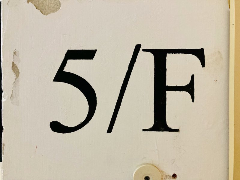 a close up of a number on a door on the fifth floor symbolizing the five stages suggested for editing AI generated content