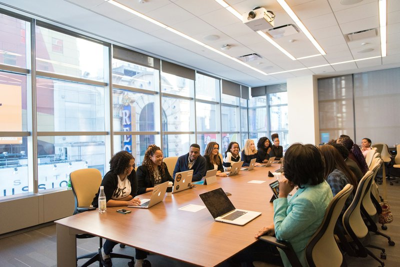 a room full of people around a conference table implementing a grant approval process