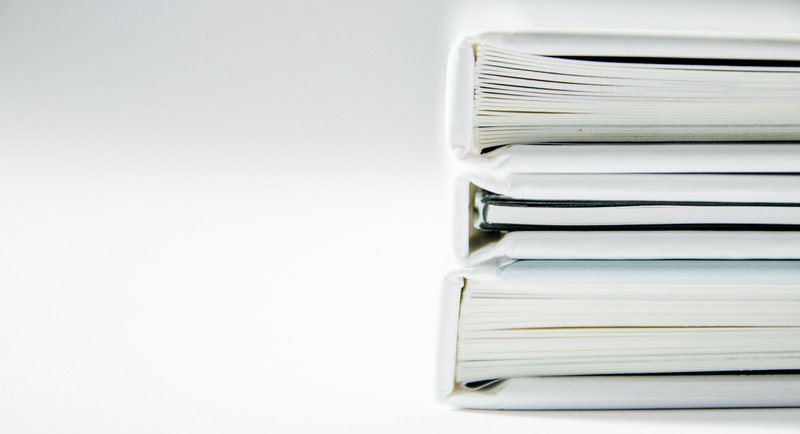 reference books stacked which symbolize guides for types of grants