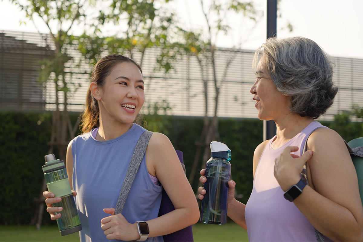 Two ladies talking and drinking water