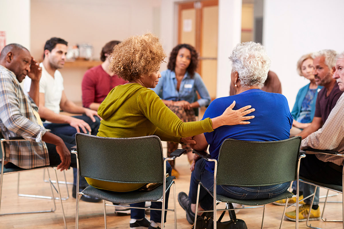 Woman comforting another woman in a support group