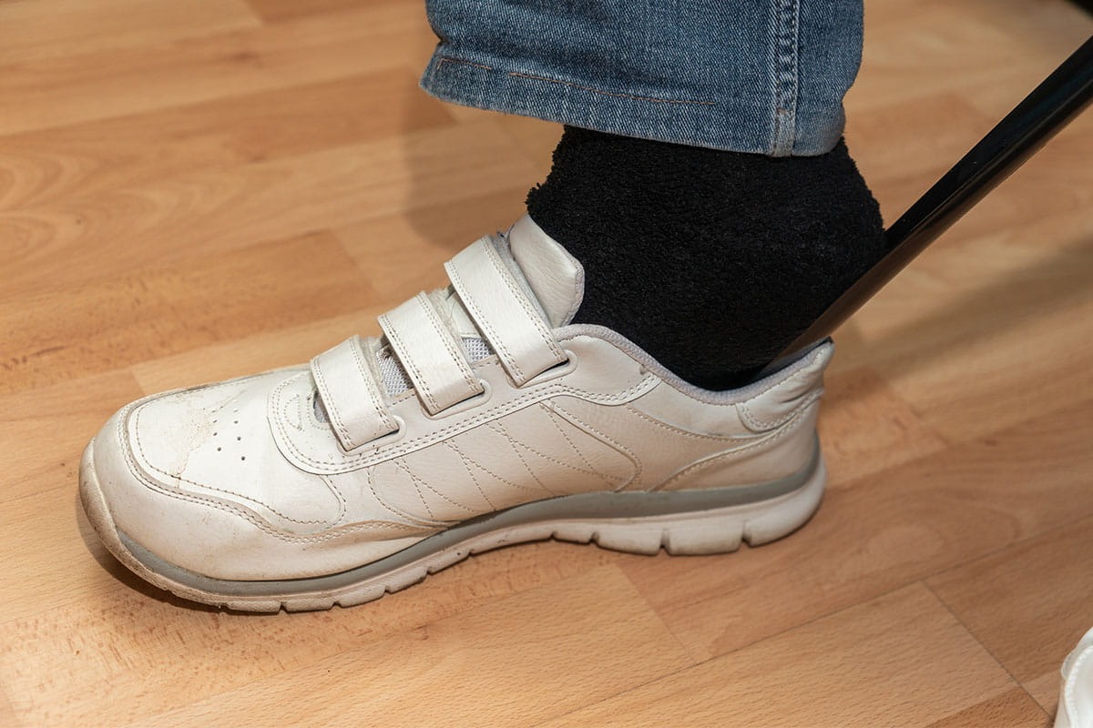 Putting on velcro shoes