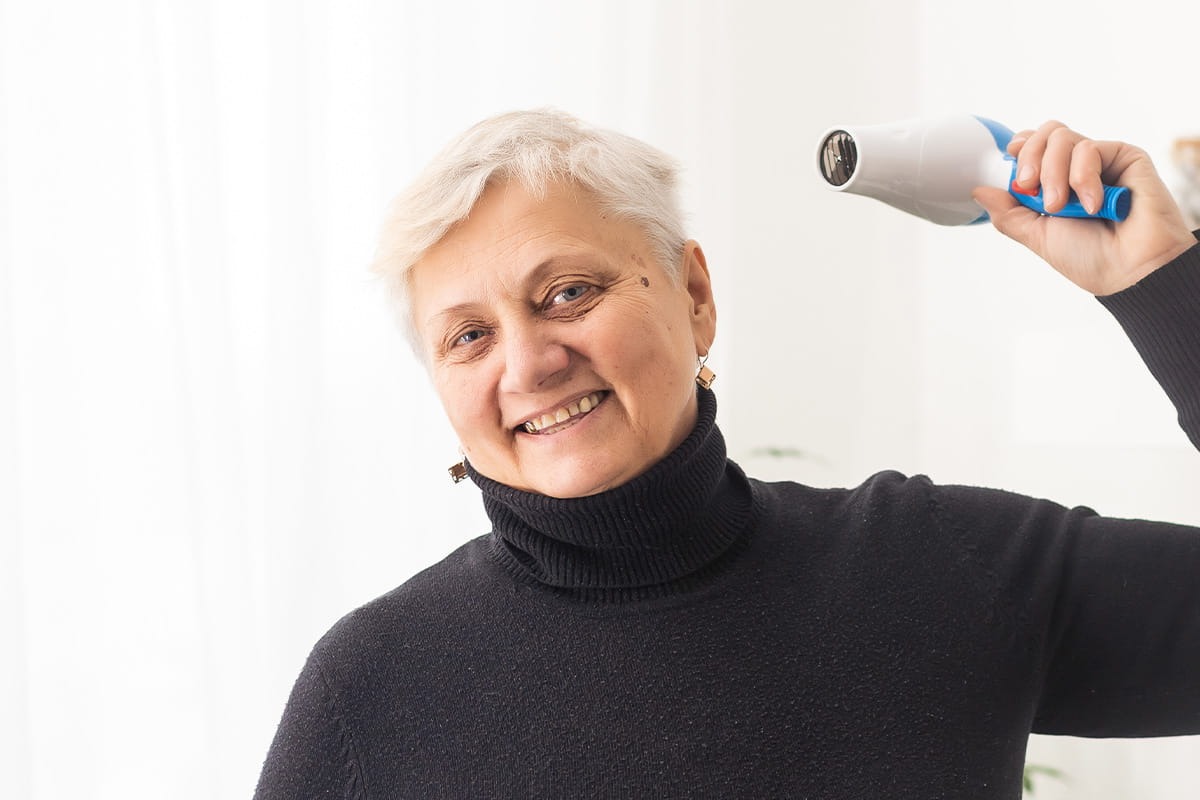 Woman blow drying hair