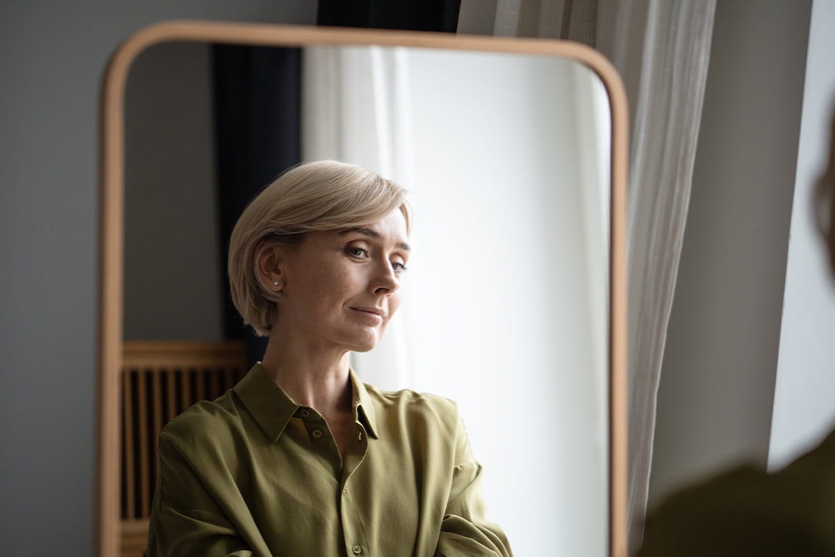 Looking at herself in the mirror