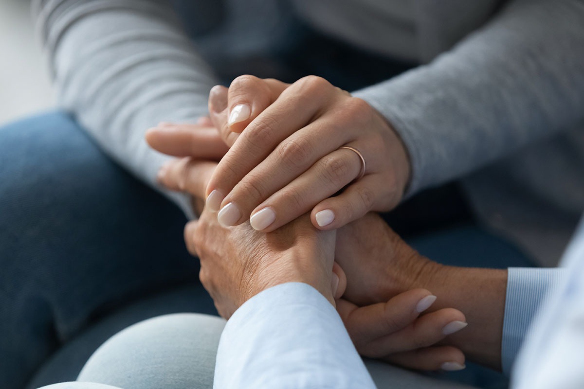 supporting someone by holding hands