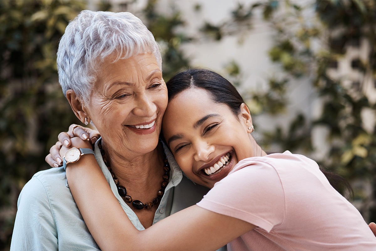 mother and daughter smiling and hugging