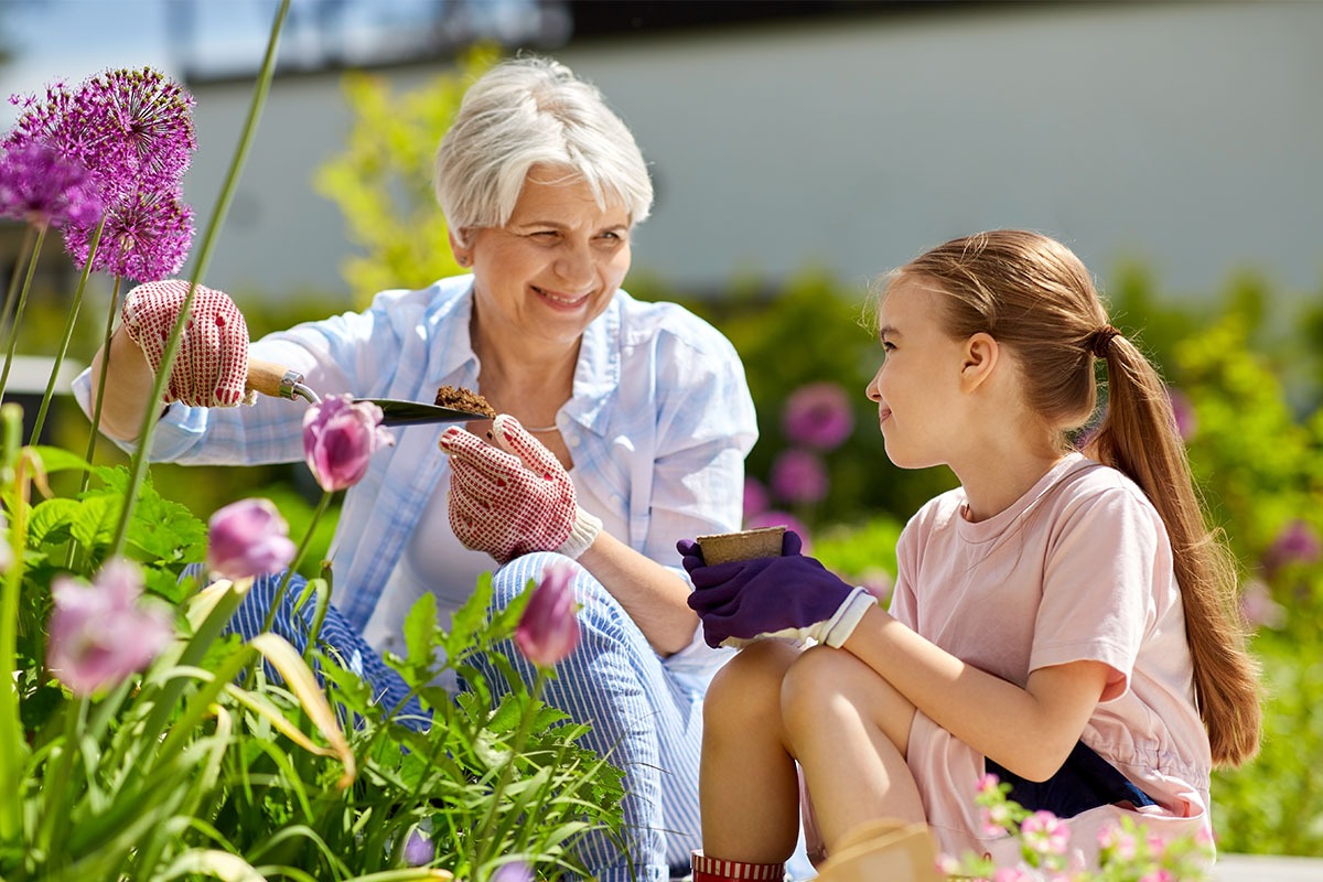 grandma gardening with her granddaughter