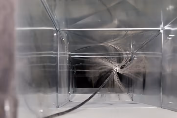 Shattered glass cube with spider web-like crack in black and white