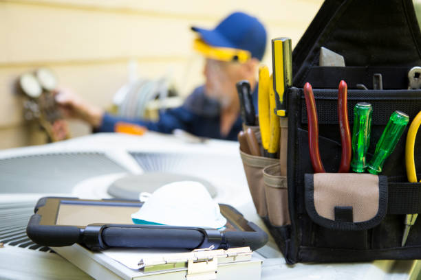 Technician's workspace with tools, clipboard, and tool belt at job site