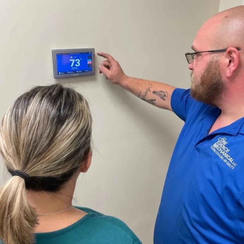 Technician cleaning HVAC coils during a spring tune-up