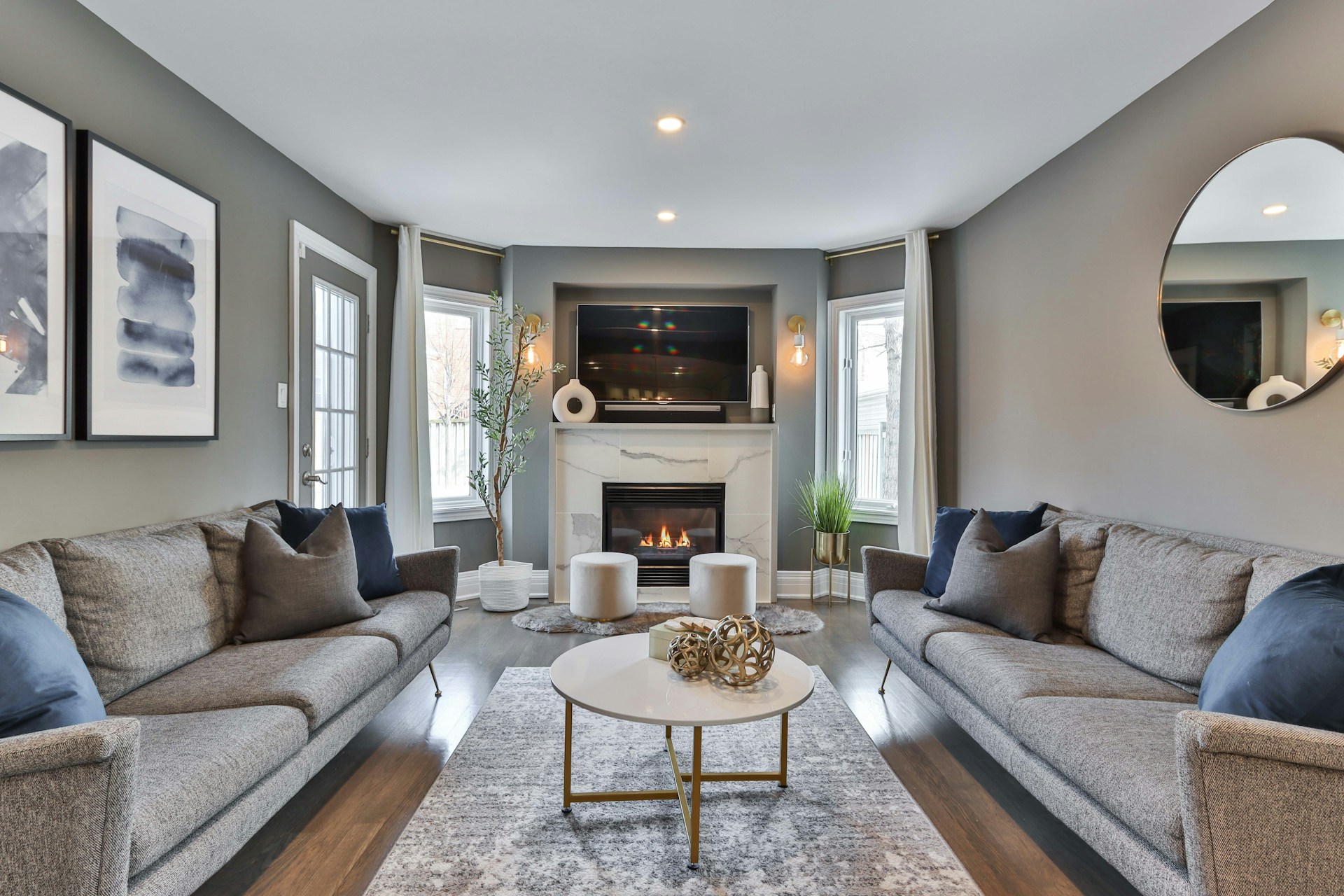 Cozy living room with gray sofas, fireplace, and modern decor