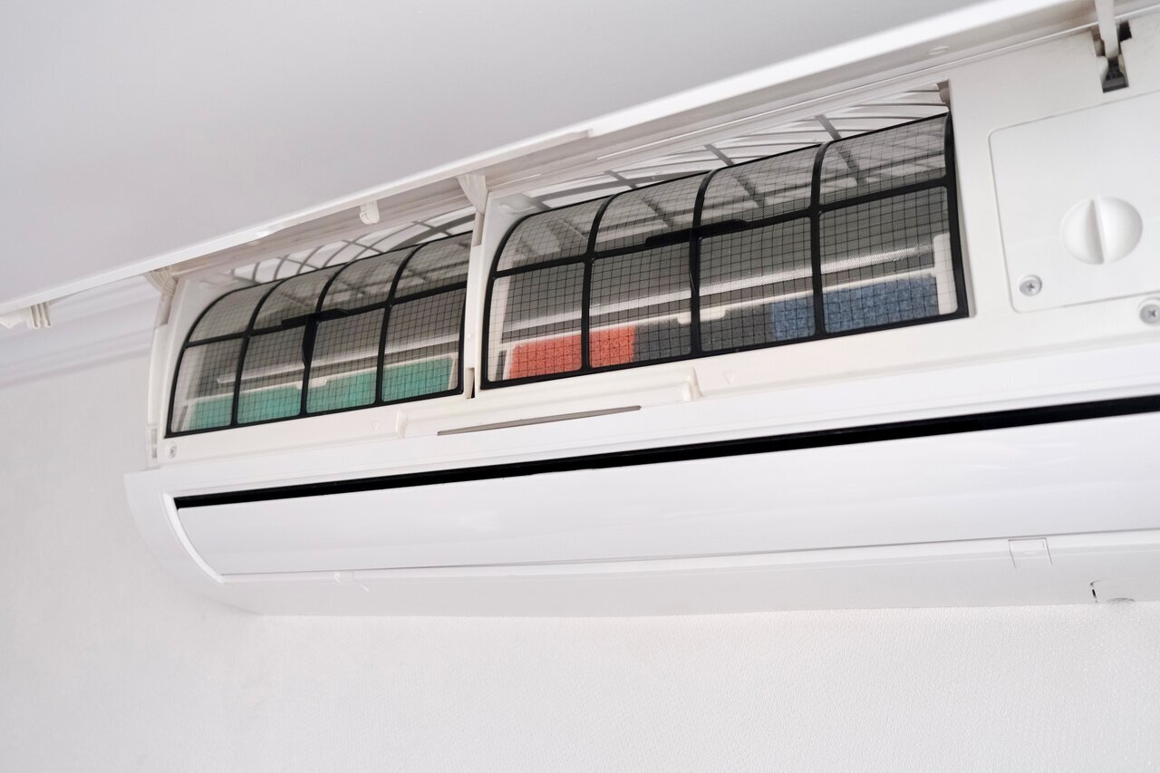 White air conditioner with colorful filter grid mounted on wall