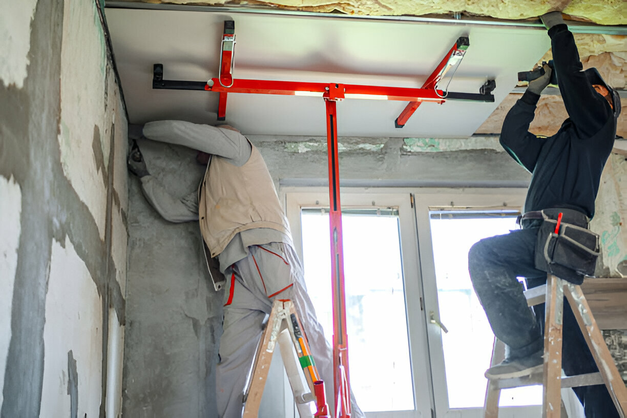 Workers using support bars and ladders during home renovation project