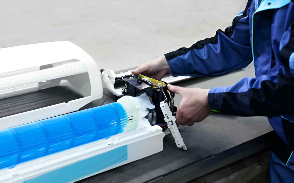 Technician repairing printer with blue and white robotic parts