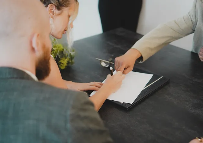 Business meeting with document signing and hands exchanging paperwork