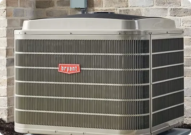 Bryant air conditioning unit installed on brick wall exterior