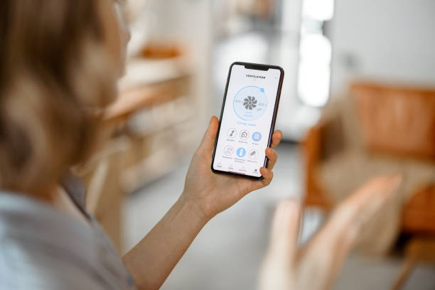 Smart home app on smartphone controlling home temperature and settings