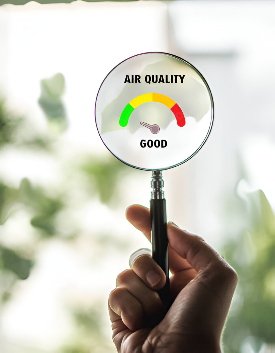 Magnifying glass showing good air quality meter with green, yellow, red scale
