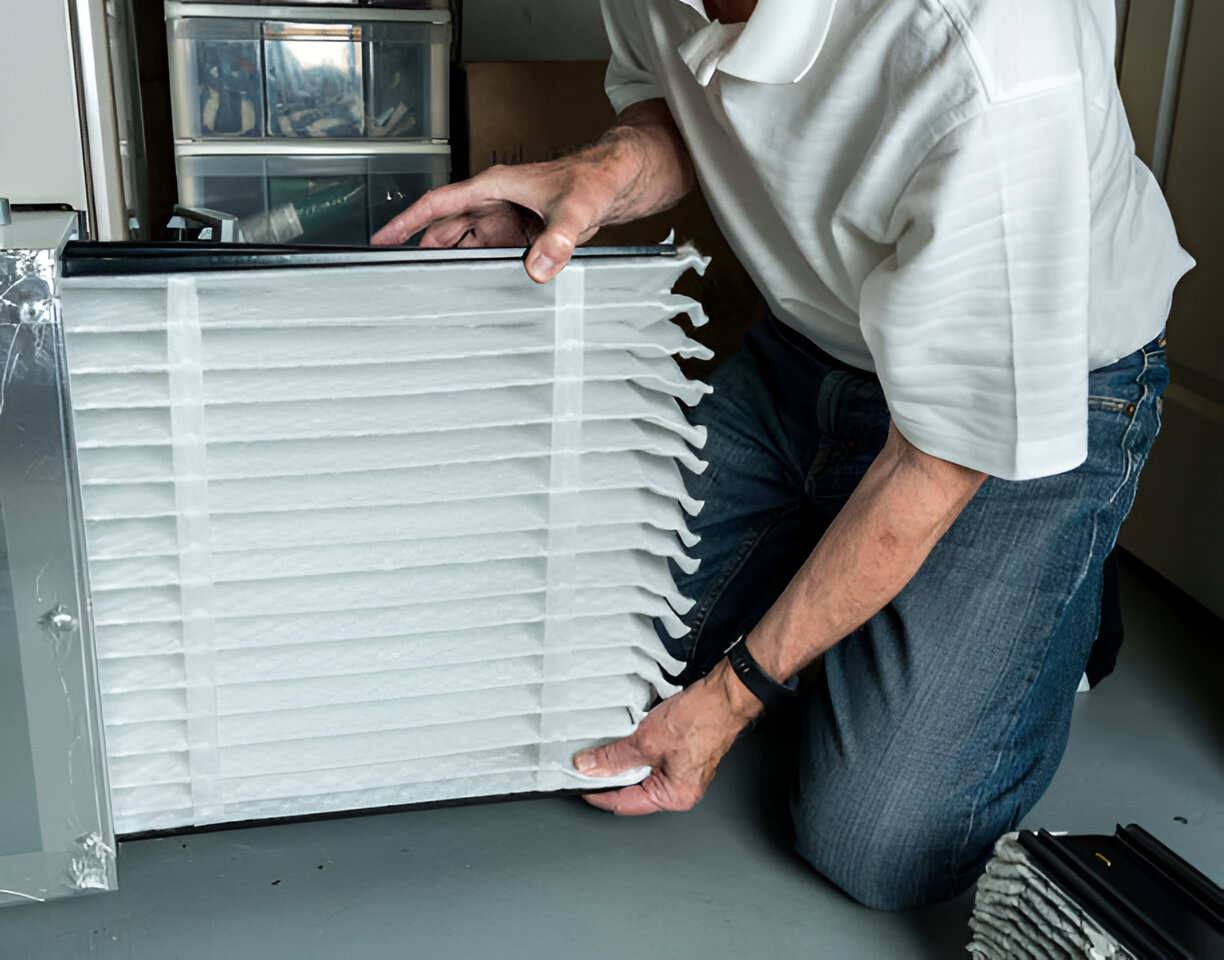 Person installing or adjusting a white air filter in a mechanical system