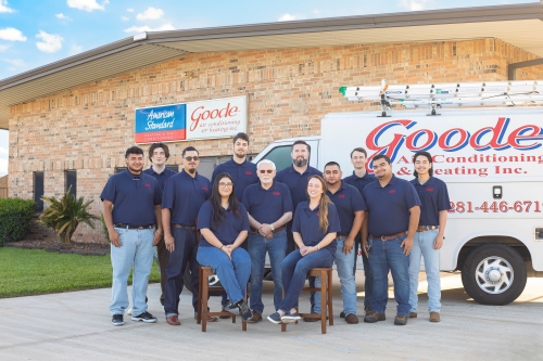 Goode Air Conditioning team posing outside their business building