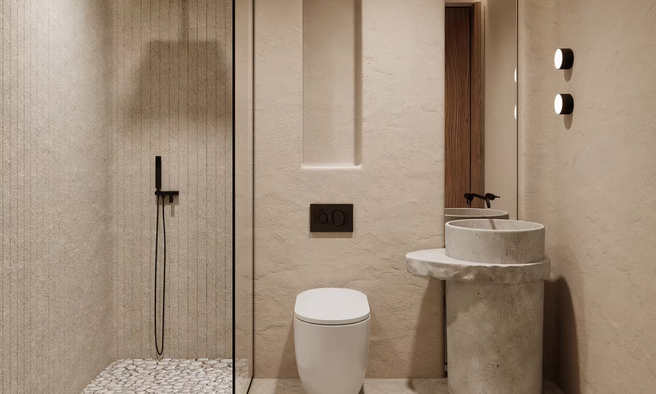 Two bedroom apartment at Azure Paje: bathroom with a stone pedestal basin, pebble floor and walk-in shower