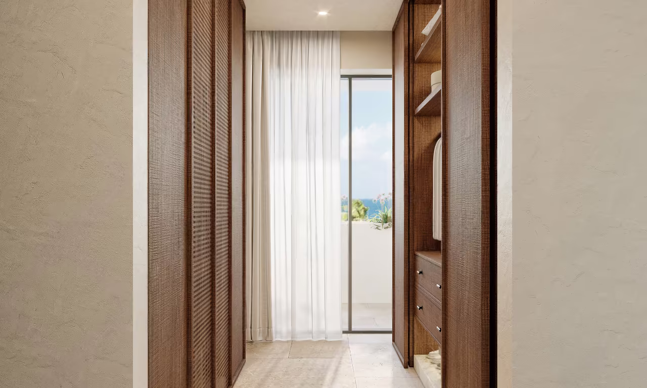 Trophy Penthouse at Azure Paje: walk-through dressing room with timber wardrobes