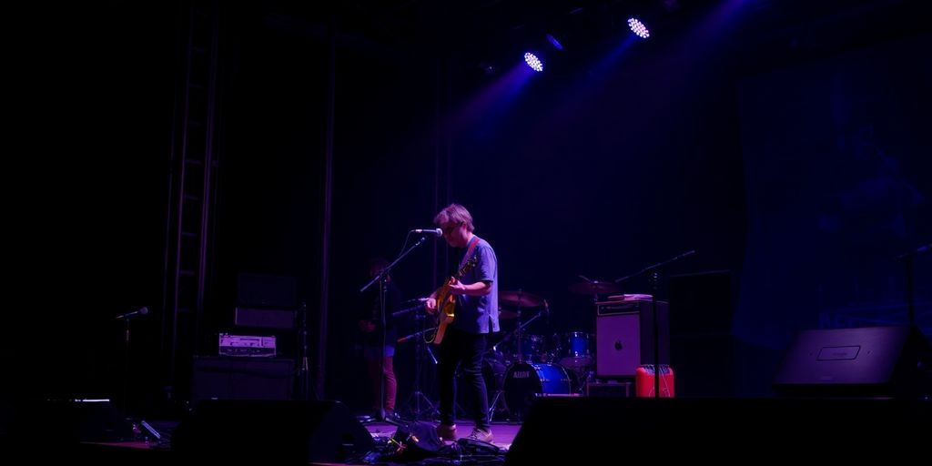 Musician performing on stage with equipment.