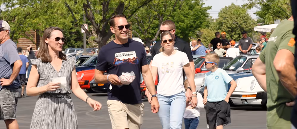 Guests walking among classic Porsche cars at Idaho Air & Coffee.