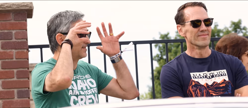 Attendees watching classic Porsche cars at Idaho Air & Coffee event.