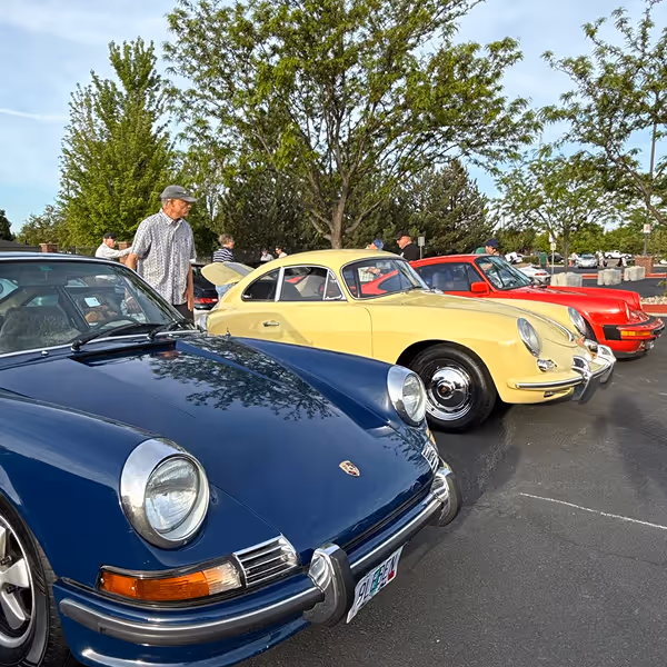 Guests walking among classic Porsche cars at Idaho Air & Coffee.