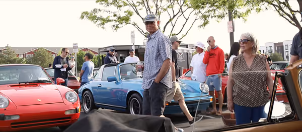 Attendees walking among classic Porsche cars at Idaho Air community event