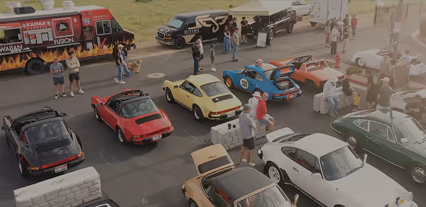 Attendees and classic Porsche vehicles displayed at Idaho Air automotive community event
