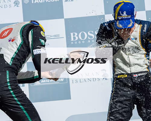 Kellymoss Porsche racing team celebrating on podium.