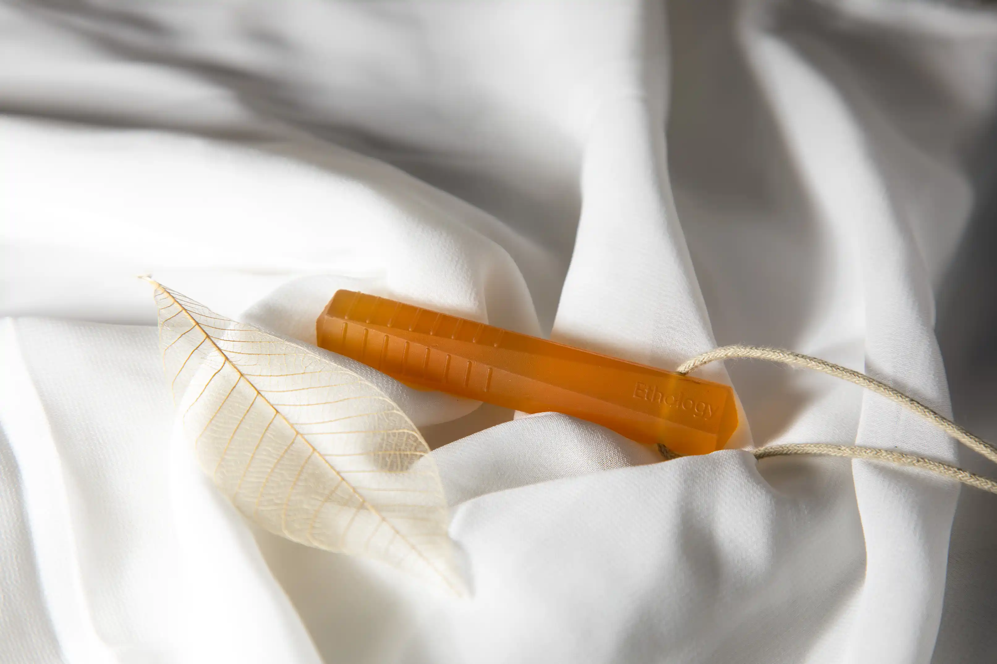 an autism chew on a white cotton background