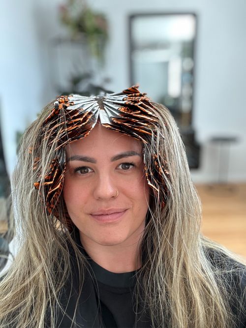 Harmony Tera, founder of Swapp, mid-hair appointment with foils in, using the Swapp app to organise her treatments.