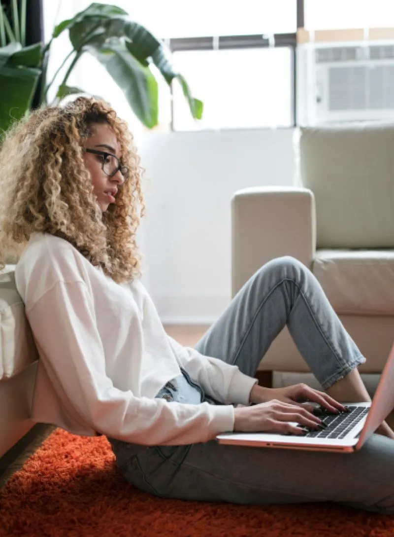 A woman is typing on laptop