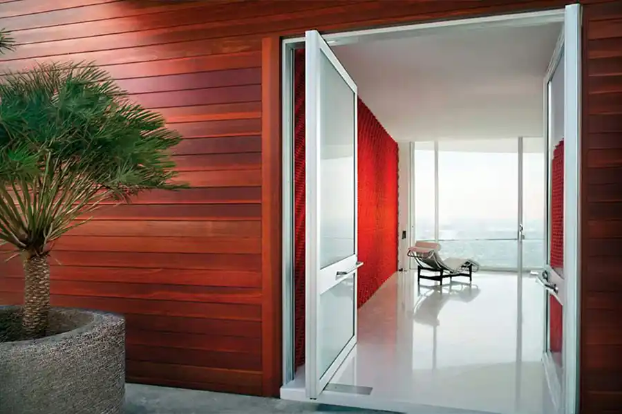 Oversized Weiland pivot door rotating open as an architectural entry