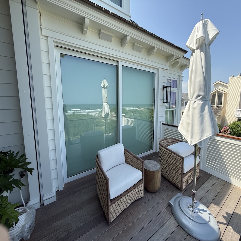 Weiland liftslide glass doors opening a wall to an outdoor coastal living space