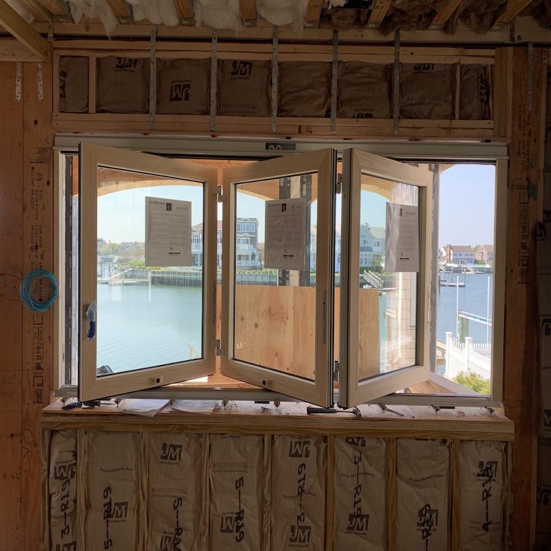 Weiland bifold doors opening a wall in sections on a shore home