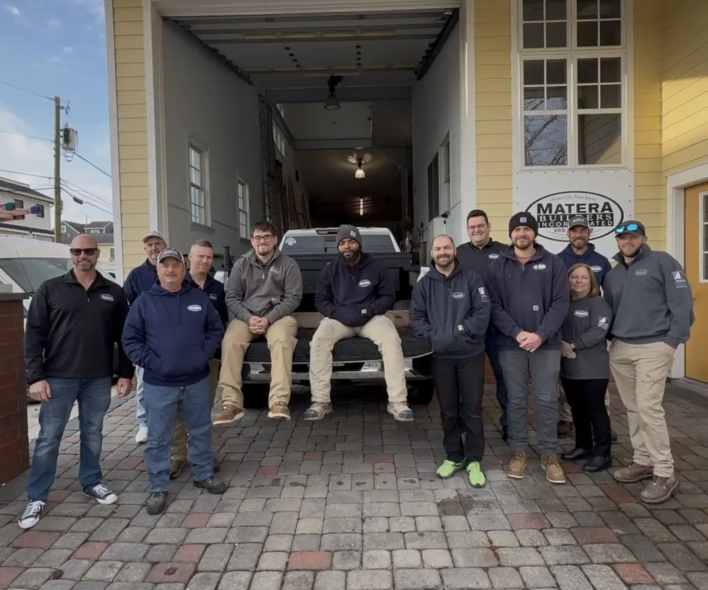 Matera Builders team standing together outside their Ocean City, NJ office and Andersen Windows showroom