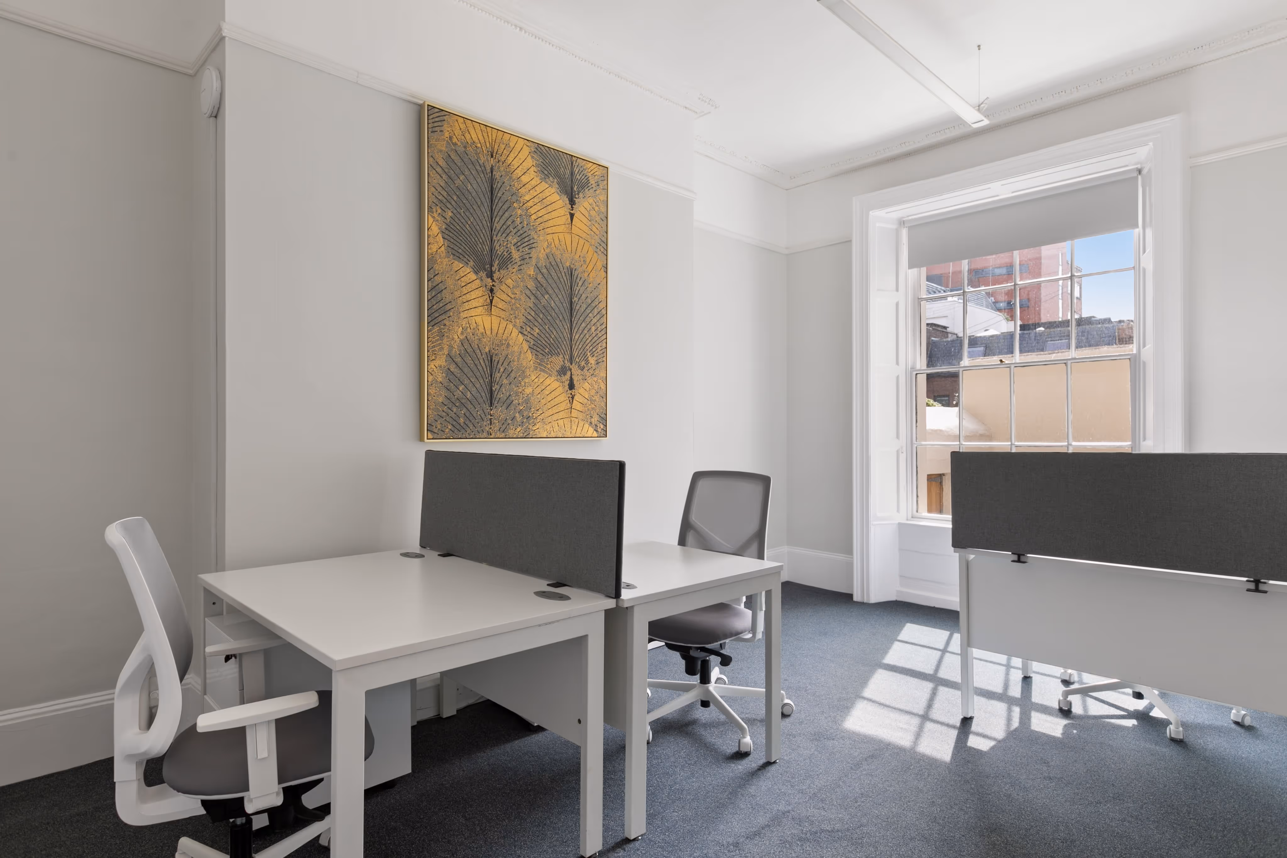Small private offices with desks and seating