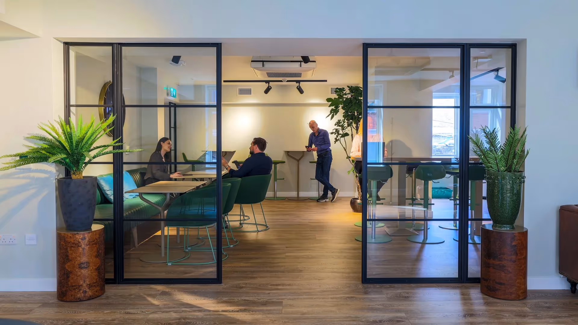 Co workers speaking in communal office space