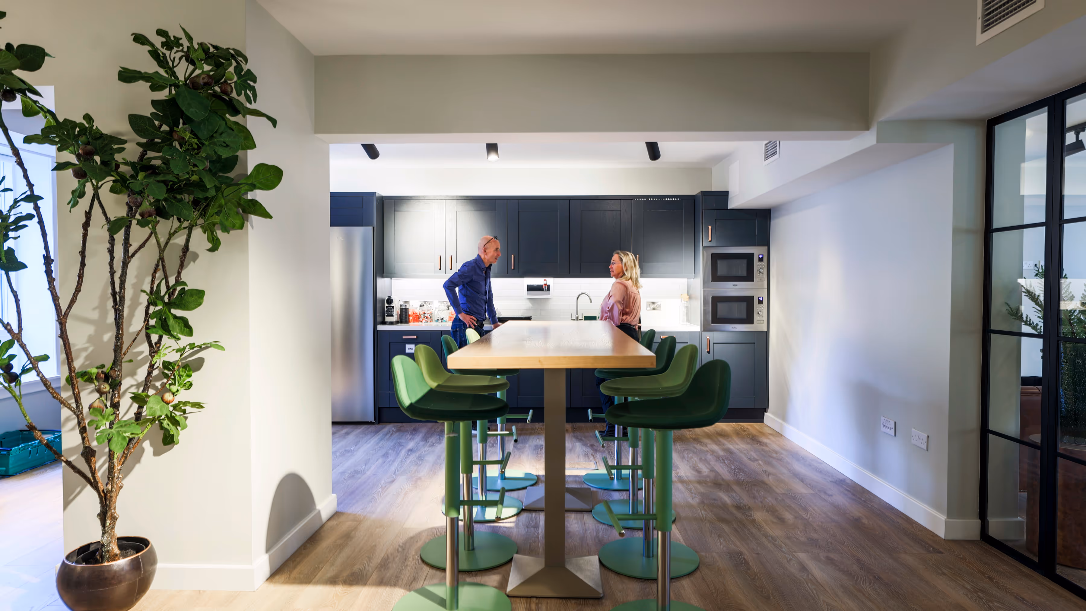 Colleagues chatting in kitchen