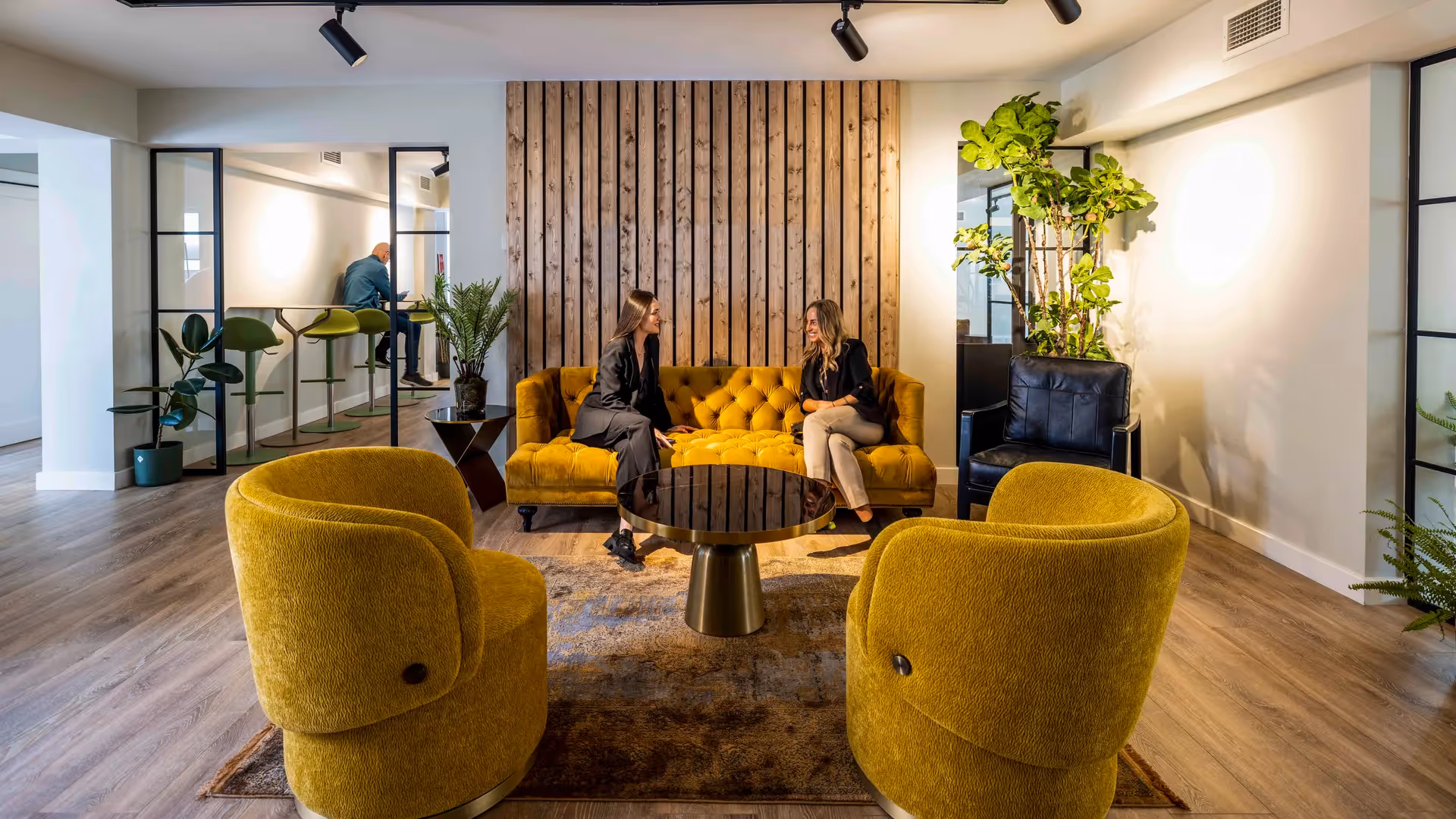 members speaking on sofa at office