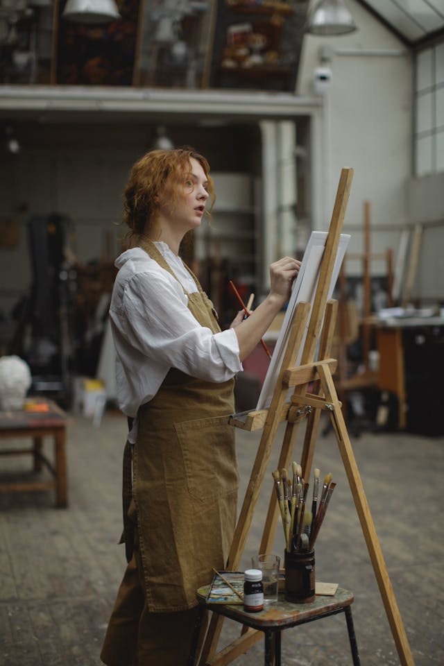 A woman painting in her art studio.