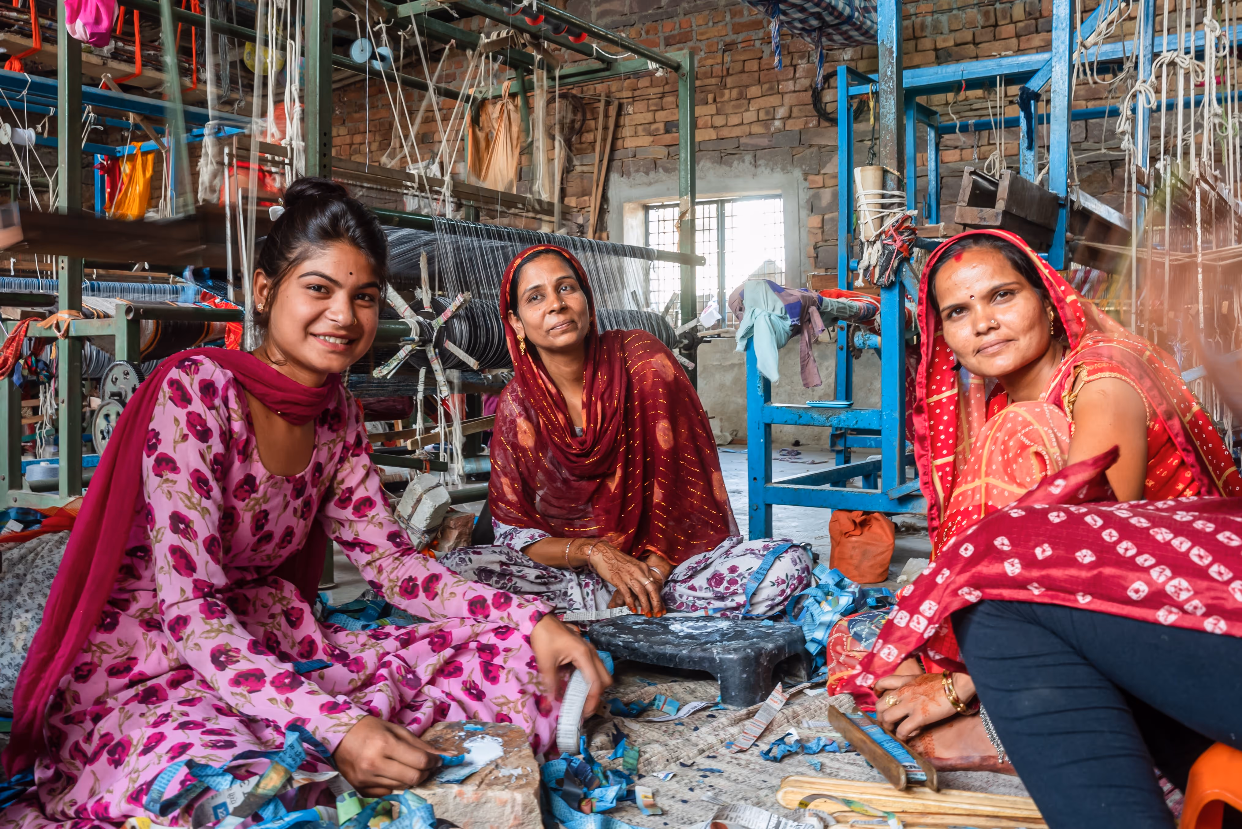 Women Artisans hand-weaving newspaper