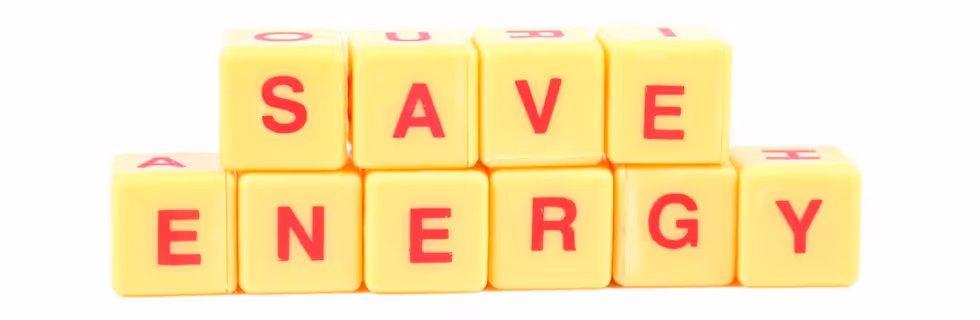 Yellow blocks spelling out "SAVE ENERGY" in bright red letters