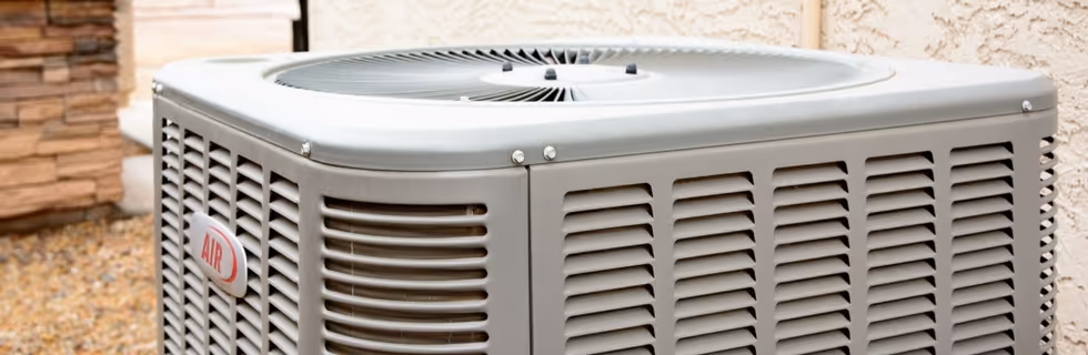 Outdoor air conditioning unit with fan and vents on residential property