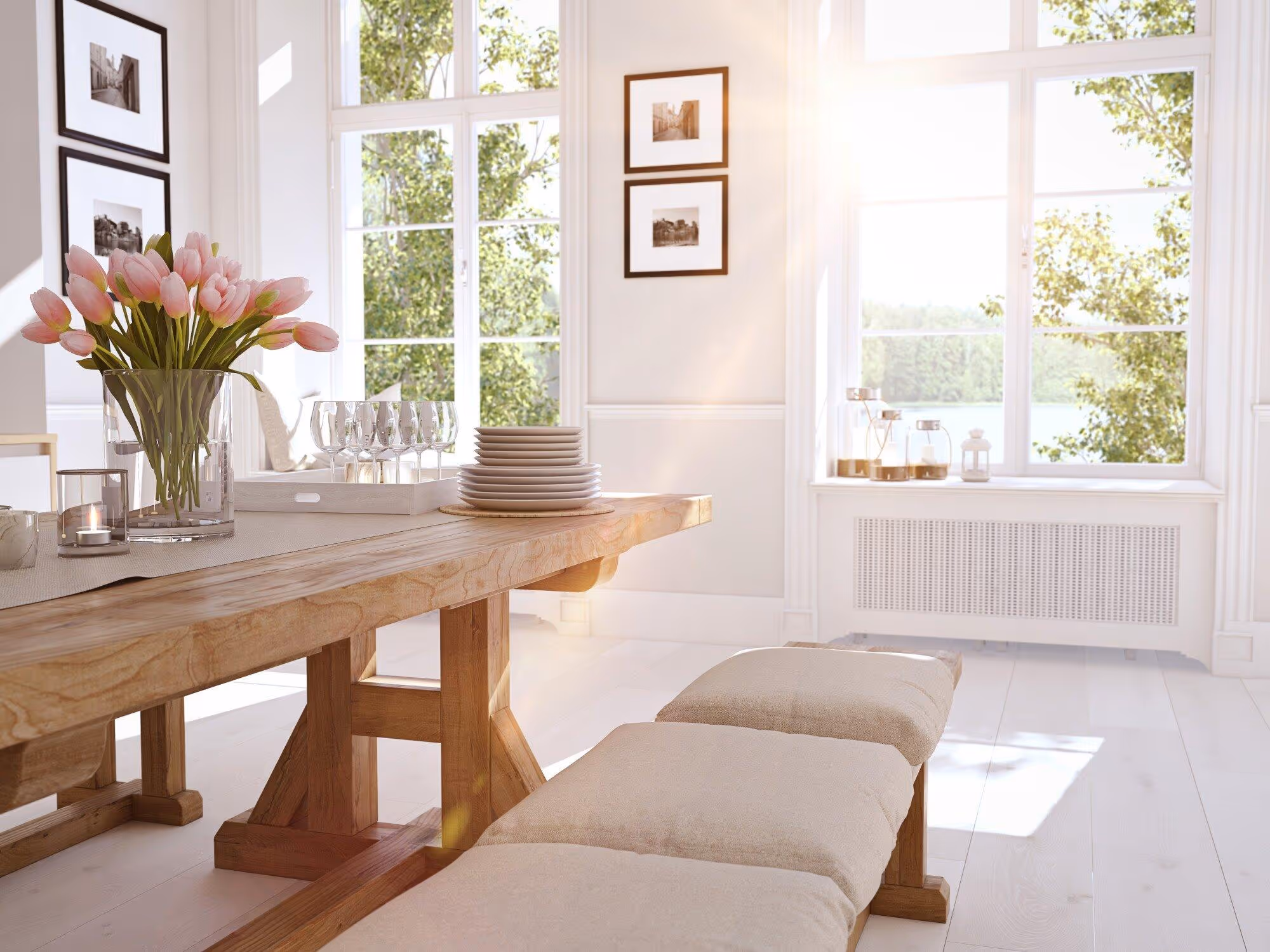 Bright dining room with wooden table, pink tulips, and sunlit windows